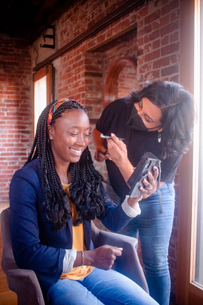 Two participants laughing together between setups